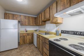 Pittsburgh apartment for rent - a kitchen with white appliances and wooden cabinets