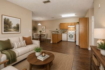 Huntsville apartment for rent - A living room with a couch, a table, and a painting on the wall.