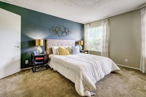 Pittsburgh apartment for rent - a bedroom with a bed and a green wall and a window