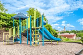 Pittsburgh apartment for rent - a playground with a blue slide in a park
