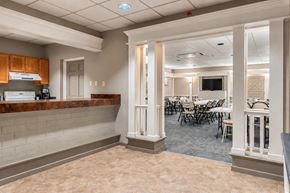 Pittsburgh apartment for rent - A room with a bar area and a dining area with chairs and tables.