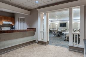 Pittsburgh apartment for rent - a lobby with pillars and a counter and a dining room with tables and chairs