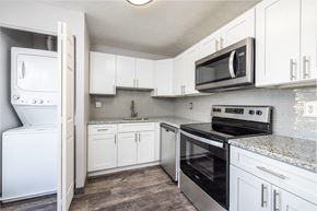 South Park apartment for rent - A kitchen with white cabinets and a black microwave above the stove.