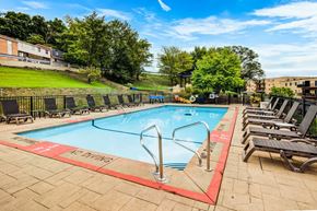 South Park apartment for rent - A pool with a red border and a sign that says "Do Not Dive" is surrounded by lounge chairs.