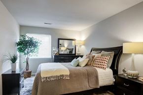 Harrisburg apartment for rent - a bedroom with a bed and a dresser and a window