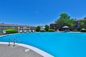 Harrisburg apartment for rent - a large swimming pool with a building in the background