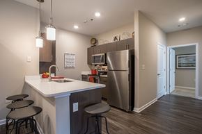 Baldwinsville apartment for rent - a kitchen with a counter top and a stainless steel refrigerator