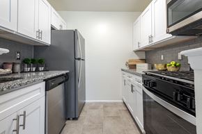Niskayuna apartment for rent - a kitchen with stainless steel appliances and white cabinets
