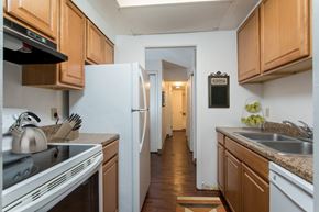Guilderland Center apartment for rent - A kitchen with wooden cabinets and a white refrigerator.