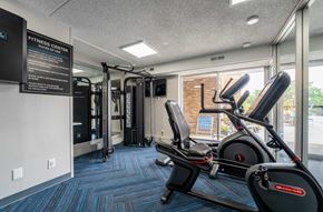 Guilderland Center apartment for rent - A fitness center with a treadmill and a sign on the wall.