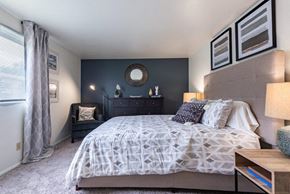 Syracuse townhouse for rent - a bedroom with a bed and a dresser and a window