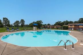 Syracuse townhouse for rent - a large swimming pool with chairs around it