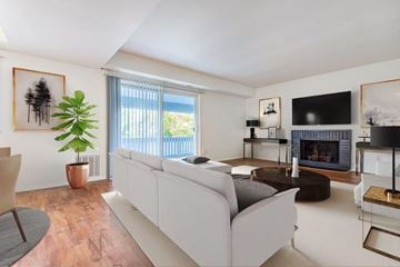 Syracuse apartment for rent - a living room with a white couch and a fireplace