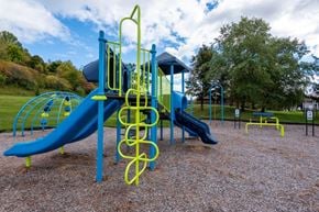 Camillus apartment for rent - a playground at a park with a blue and yellow swing set
