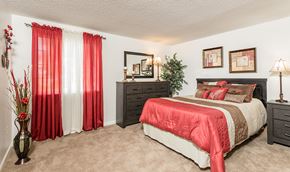 Hamburg apartment for rent - a bedroom with a bed and a window with red curtains