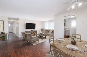 Tonawanda apartment for rent - A dining room with a wooden table set for four.