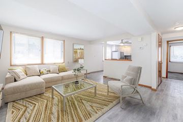 Tonawanda apartment for rent - A living room with a glass coffee table and a beige sofa.