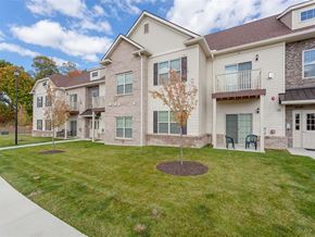 Canonsburg apartment for rent - A tree in a small circle of dirt stands in front of a building with a lawn in front of it.