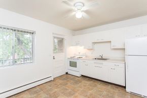 Pittsford apartment for rent - A kitchen with white appliances and cabinets.