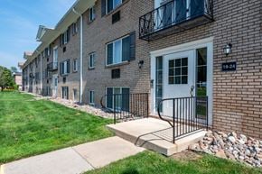 Pittsford apartment for rent - Apartment building number 19-24 has a white door and a black gate.