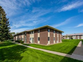 Webster apartment for rent - A long building with a green lawn in front.