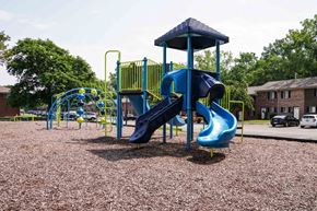 Rochester townhouse for rent - A playground with a blue slide and yellow railing.