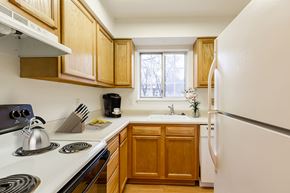 Rochester townhouse for rent - kitchen with oak cabinets and white appliances