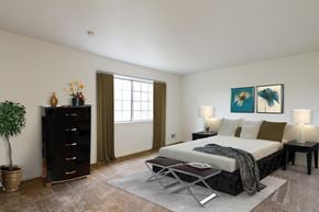 Rochester townhouse for rent - large, staged bedroom with wall to wall carpet