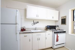 Rochester apartment for rent - Kitchen with classic white cabinets and white appliances