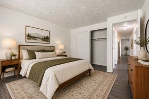Webster apartment for rent - A bedroom with a large bed and a painting on the wall.
