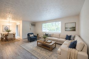Webster apartment for rent - A living room with a couch, chairs, and a coffee table.
