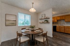 Webster townhouse for rent - A dining room with a table set for two and a view of the backyard.
