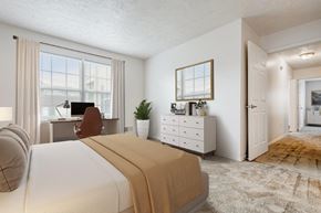 Rochester apartment for rent - a bedroom with a bed and a desk