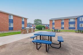 Rochester apartment for rent - our picnic tables are in front of our building with our apartments in the background