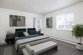 Rochester apartment for rent - a bedroom with a bed and a couch