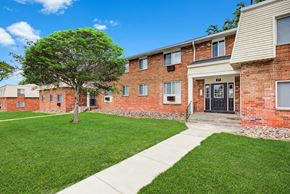 Rochester apartment for rent - an apartment building with a lawn and a sidewalk