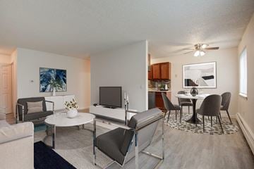 Fairport apartment for rent - a living room and kitchen with a table and chairs