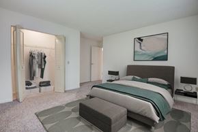 Fairport apartment for rent - a bedroom with a bed and a closet