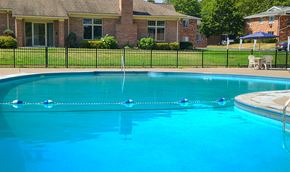 Fairport apartment for rent - a large swimming pool with a house in the background