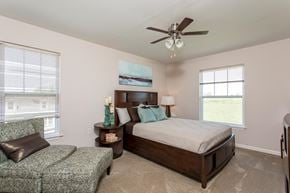 Watertown townhouse for rent - a bedroom with a bed and a ceiling fan