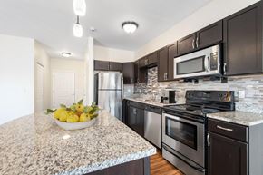 Rochester apartment for rent - a kitchen with stainless steel appliances and granite counter tops