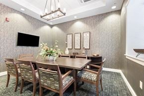 Rochester apartment for rent - a dining room with a large table and chairs