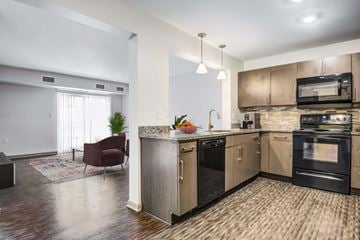 Rochester apartment for rent - a kitchen with an island and a living room with a couch