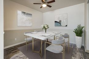 Rochester apartment for rent - a dining room with a table and chairs and a ceiling fan