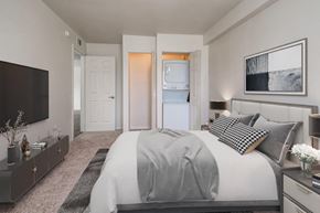 Rochester apartment for rent - a bedroom with a large bed and a tv
