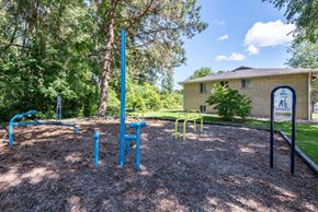 Rochester apartment for rent - a park with a playground and a house in the background