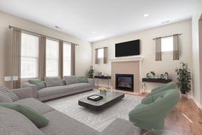 Webster apartment for rent - A living room with a grey sofa, a green armchair, and a fireplace.