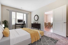 Webster apartment for rent - A bedroom with a bed, a desk, a chair, and a mirror.