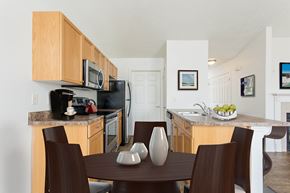 Avon apartment for rent - A kitchen with a table and chairs in the foreground.