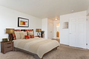 Avon apartment for rent - A bedroom with a large bed and a painting on the wall.